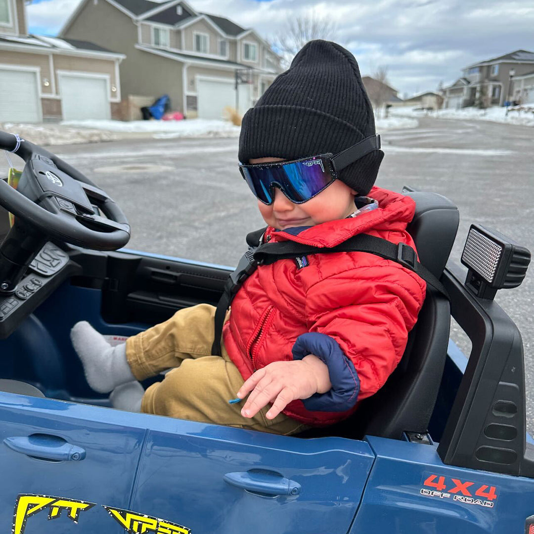 baby boy in a toy car wearing hail sagan baby vipes - lifestyle