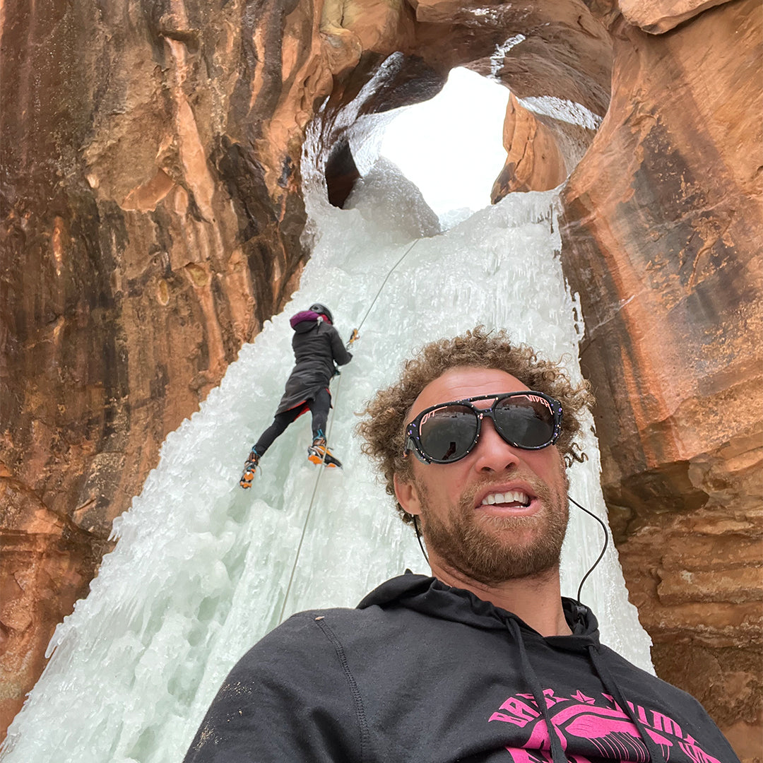 man wearing the naples exciters in front of a waterfall - lifestyle